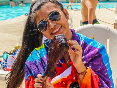 Girl holding chicken wing - Smokehouse at Wet n Wild