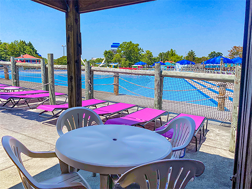 Cabana at Wet n Wild with table and chairs next to pool